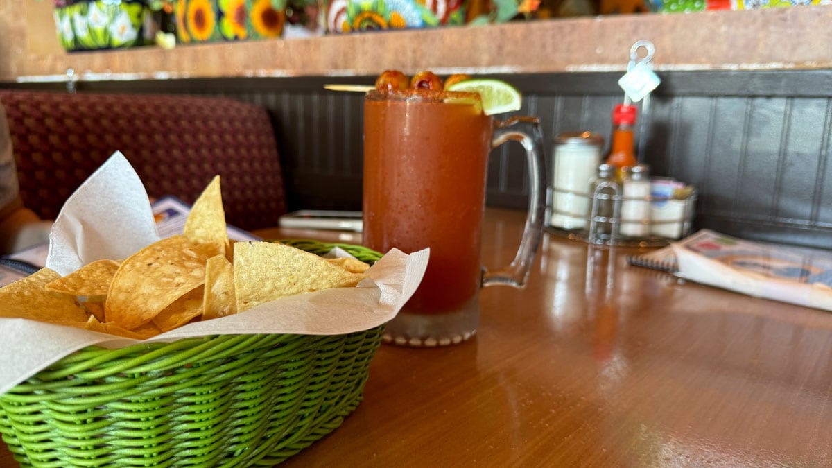 michelada served at Casa Don Juan with a spicy rim and lime garnish