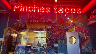 Lit Pinches Tacos sign above the kitchen area inside the Southwest Las Vegas restaurant.