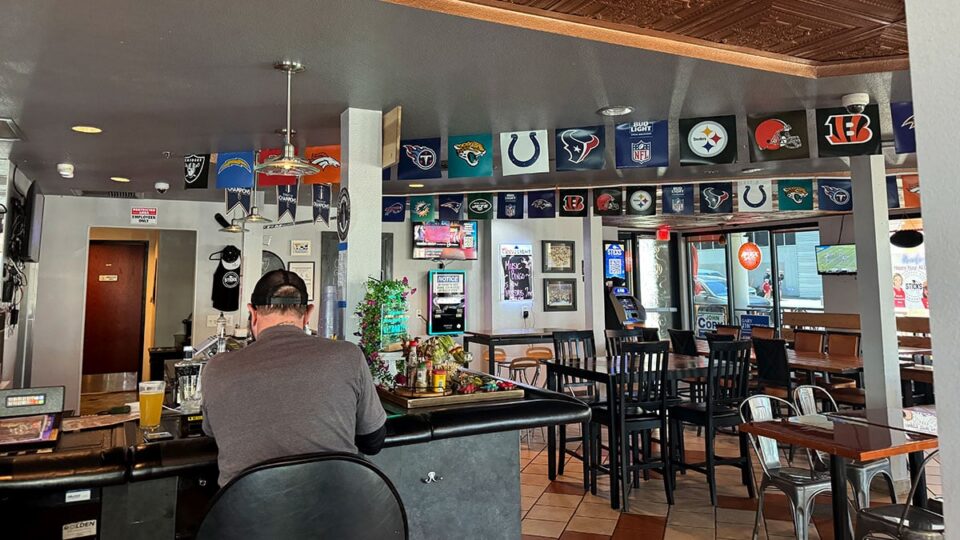 Dining tables and bar seating inside Sticks Tavern