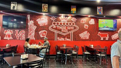 dining area inside those guys pies with seating for guests and arcade games