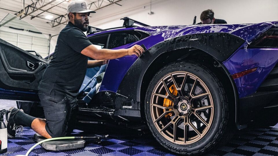 Tier 1 Autohaus technician applying paint protection film to a Lamborghini in Las Vegas