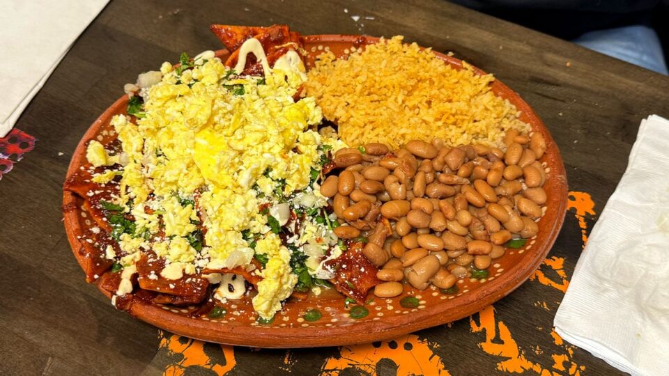 Chilaquiles rojo with crema, cotija cheese, cilantro, onion, rice and beans at Carolina's Mexican Kitchen
