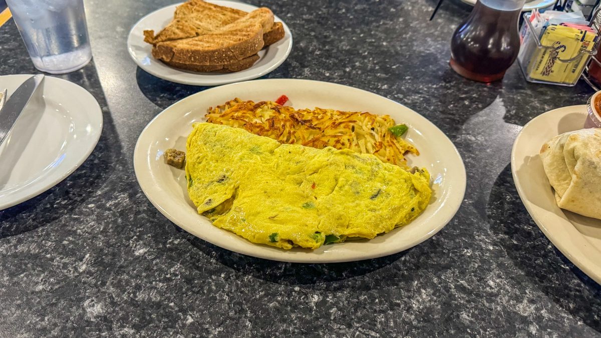 Large Mamas Omelet served with crispy hash browns and sourdough toast at Mr. Mamas Las Vegas.