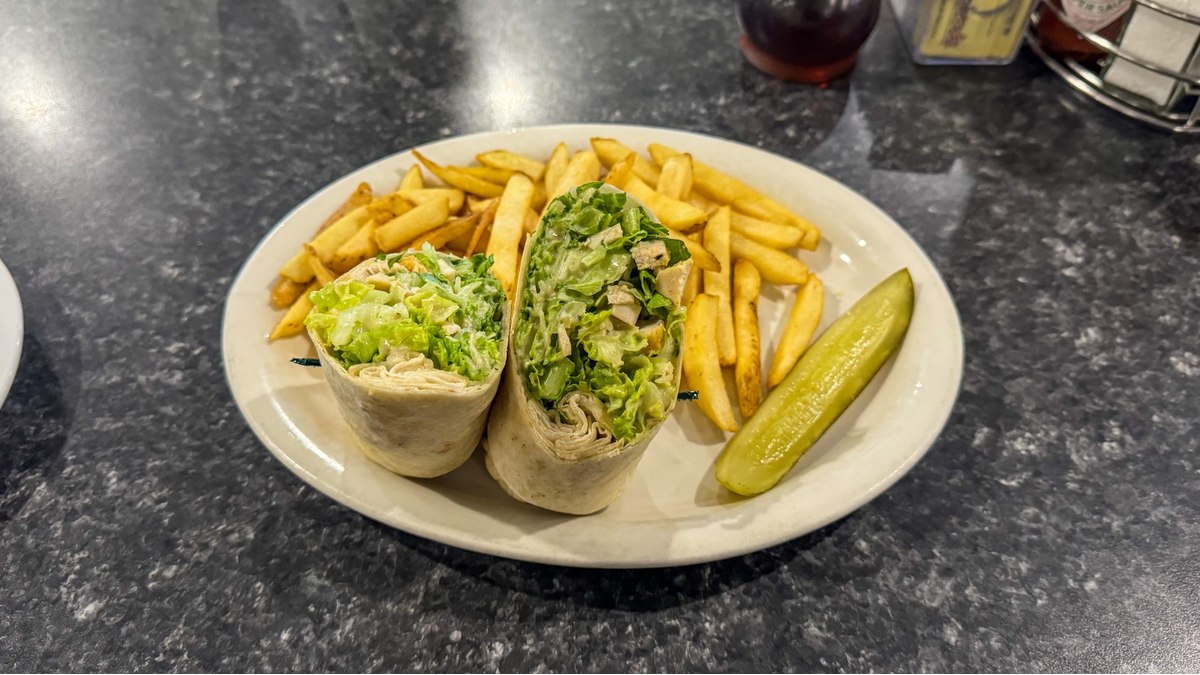 Caesar wrap with grilled chicken, fries, and pickle served at Mr. Mamas Breakfast and Lunch.