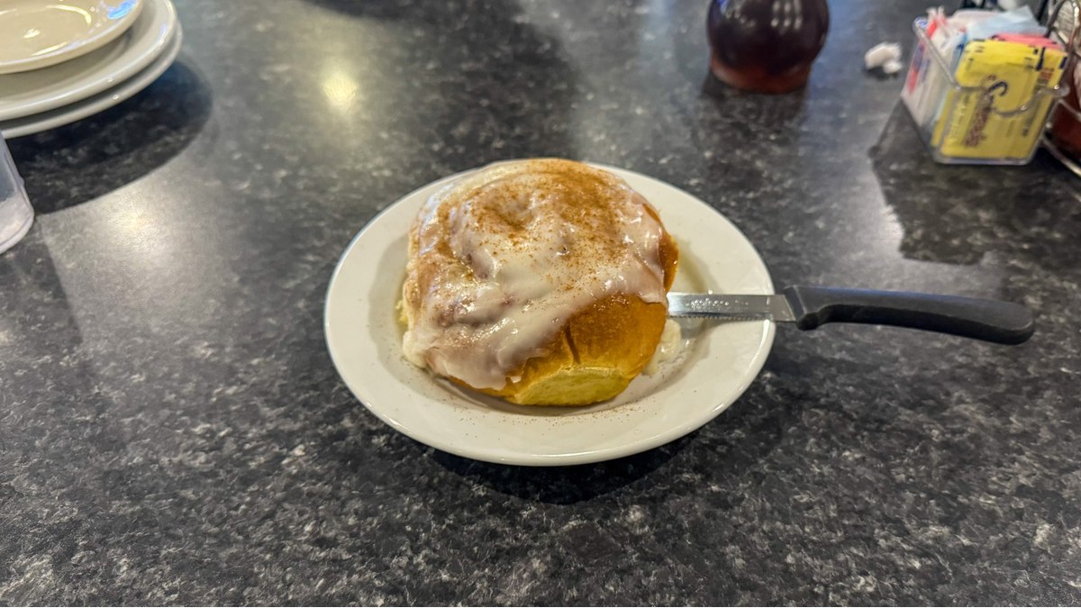 Warm cinnamon roll covered in icing served at Mr. Mamas Breakfast and Lunch in Las Vegas.