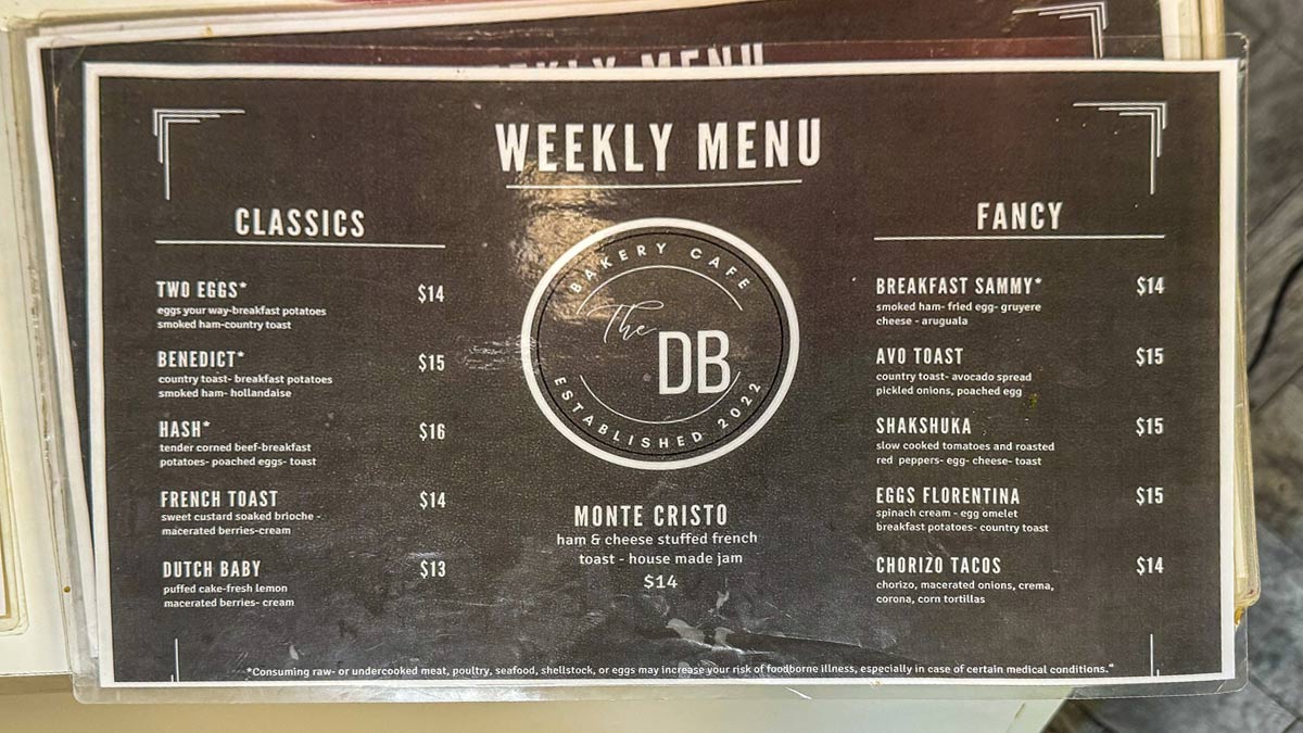 Printed breakfast and brunch menu displayed inside a bakery cafe.