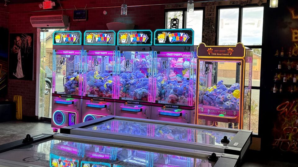 Claw machines and ice hockey game inside Dirt Dog Southwest.