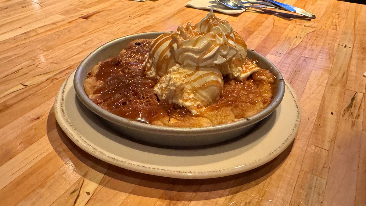 salted caramel cookie dough dessert topped with ice cream at 90 NINETY Bar + Grill