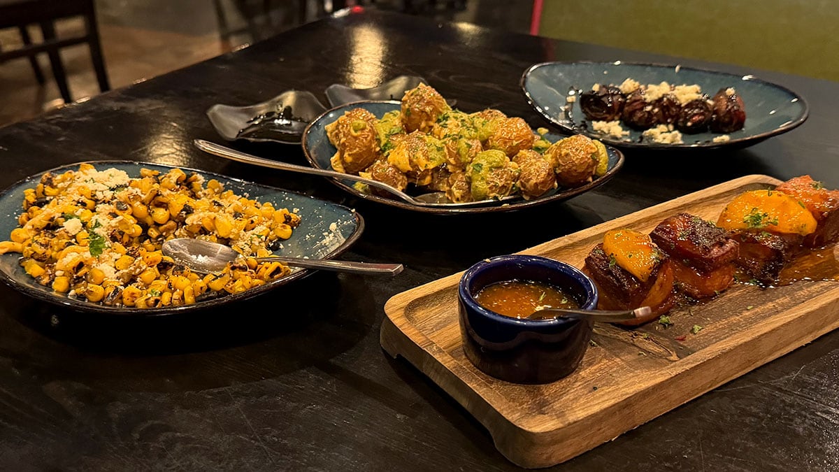 Assorted tapas dishes spread across a dining table at Tres Social Tapas in Las Vegas.