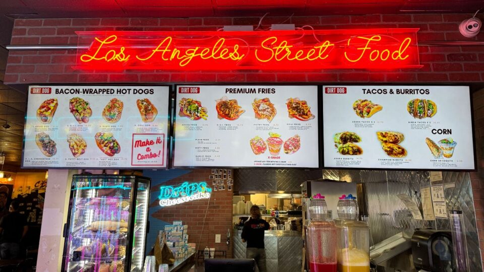 Dirt Dog menu under a Los Angeles Street Food neon sign in Southwest Las Vegas.