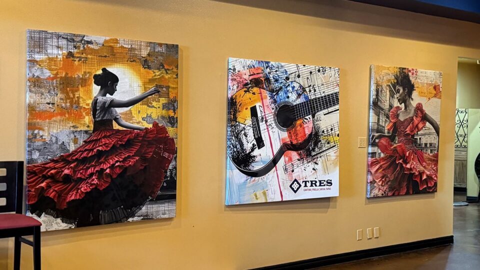 Flamenco dancer artwork displayed on the wall inside Tres Social Tapas restaurant.