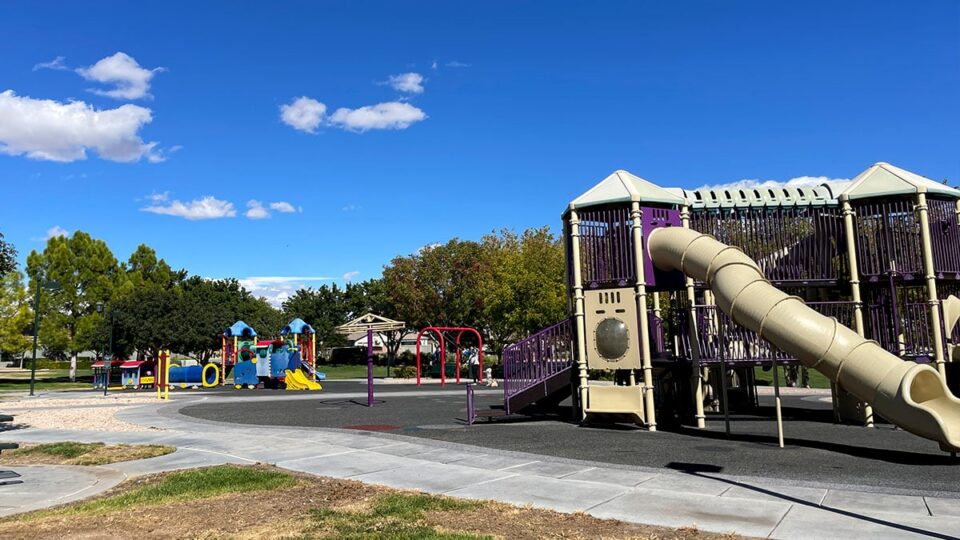 The colorful playground at Gardens Park offers separate play areas for toddlers and older kids, making it a perfect destination for families of all ages.