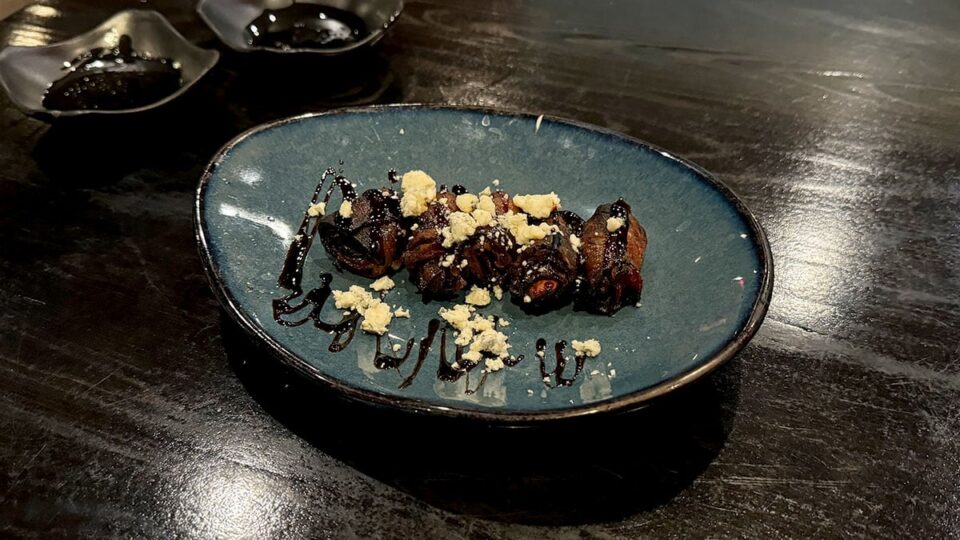 Iberico dates wrapped in bacon and topped with blue cheese, balsamic glaze, and black truffle.