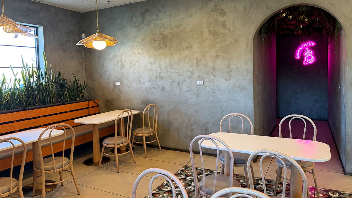Cozy interior of Mama Chai's featuring seating, colorful décor, and board games for guests.