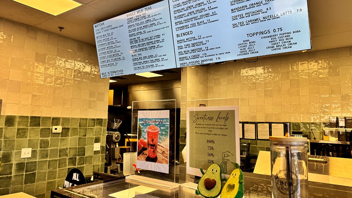 Menu board at Mama Chai's featuring boba teas, specialty drinks, desserts, and snacks.