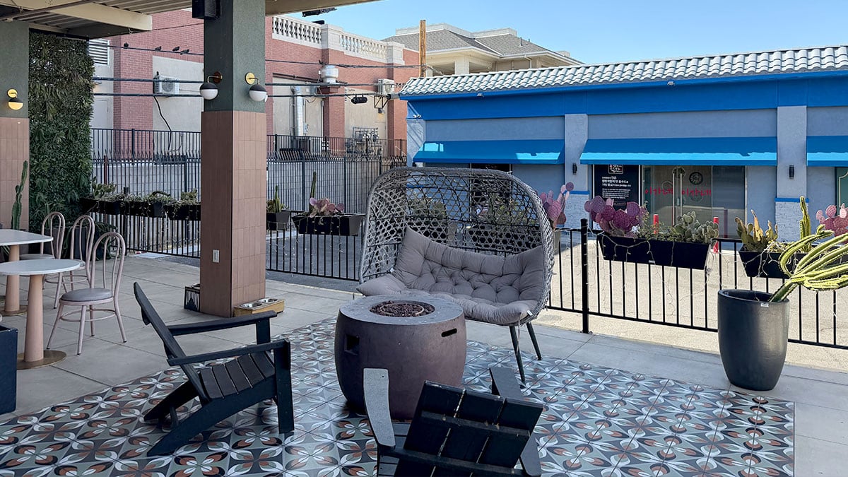 Outdoor patio seating area at Mama Chai's featuring swing tables and a cozy atmosphere.