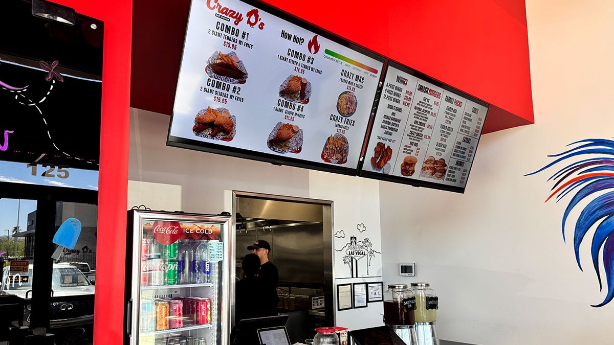 Menu board at Crazy D’s Hot Chicken featuring hot chicken combos, sandwiches, tenders, sides, and spice levels.