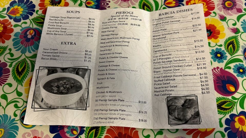Pierogi Village menu featuring traditional Polish dishes including pierogi, borscht, stuffed cabbage, and Polish sausage.