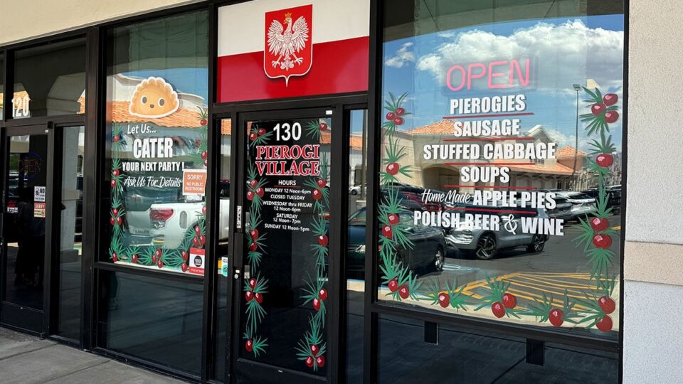 Front window of Pierogi Village decorated with Polish-themed displays and welcoming signage.