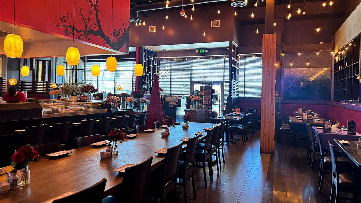 Comfortable dining area with tables and seating inside Sushi Loca.