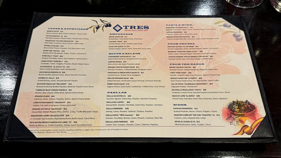Food and drink menu from Tres Social Tapas featuring tapas, seafood, steaks, and cocktails.