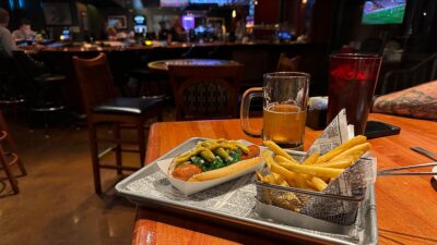 Weizenheimer German wheat beer served alongside a Chicago-style hot dog at Chicago Brewing Company in Las Vegas.
