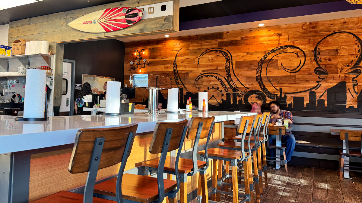 bar area inside Bajamar Seafood & Tacos featuring seating and a selection of beverages