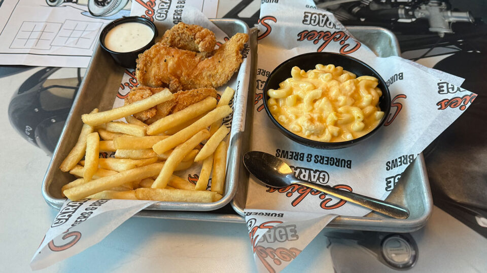 Crispy chicken tenders served with macaroni and cheese at Sickies Garage