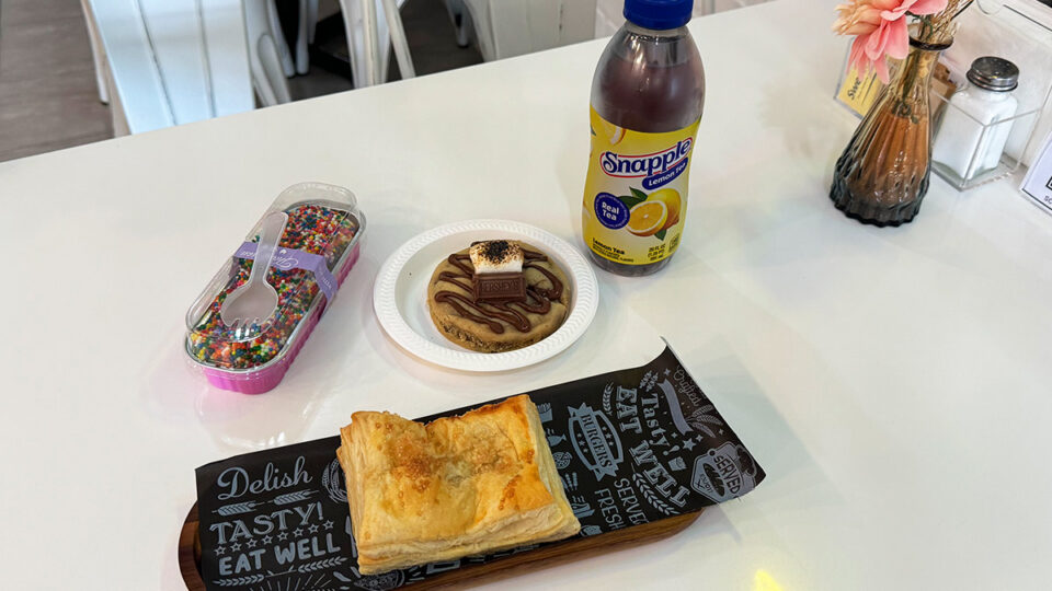 Selection of desserts and pastries including dot cake, s'mores cookie, guava empanada, and lemon tea at Cookio Cafe.