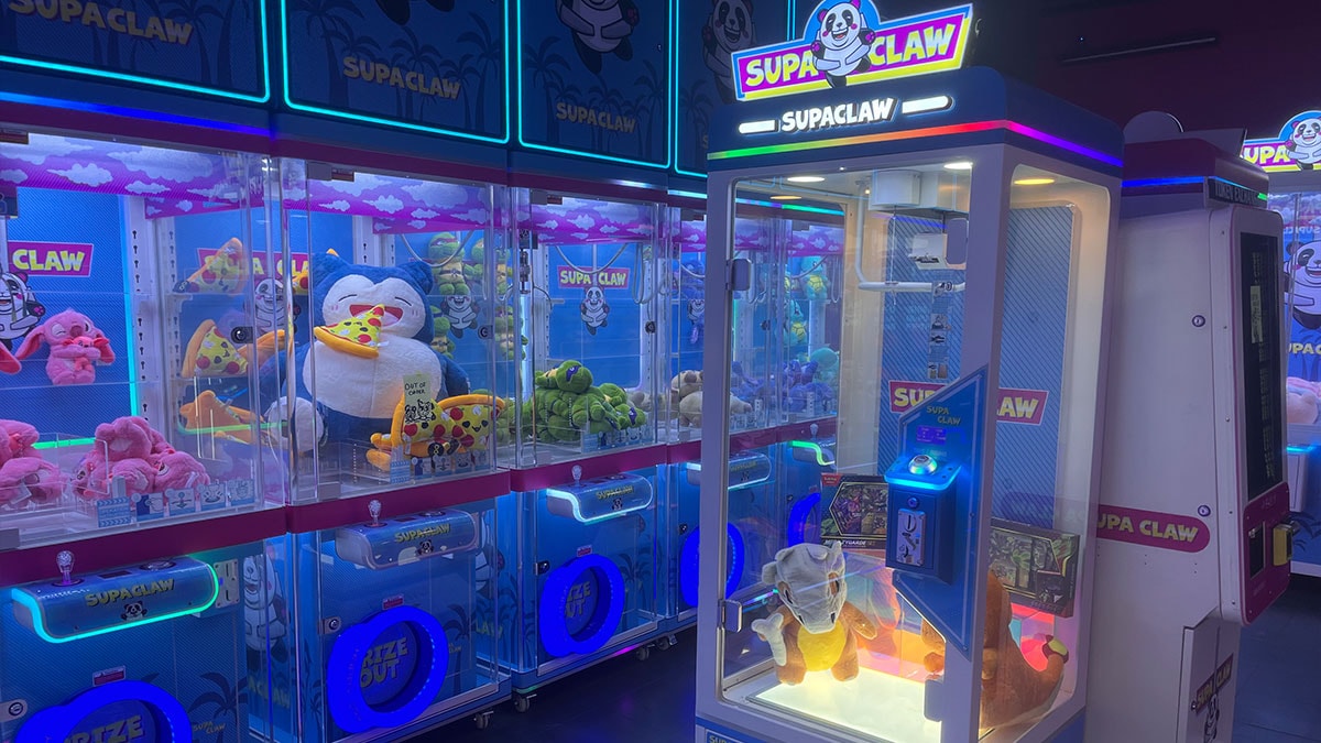 Guests playing colorful Japanese-style claw machines at Supa Claw in Town Square Las Vegas