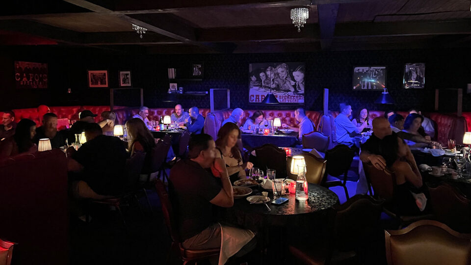 Vintage dining room inside Capo's Italian Restaurant and Speakeasy featuring classic décor, cozy booths, and a Prohibition-era atmosphere.