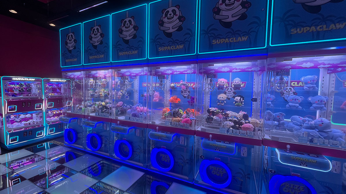 interior of Supa Claw at Town Square Las Vegas featuring colorful décor, bright lights, and rows of Japanese-style claw machines
