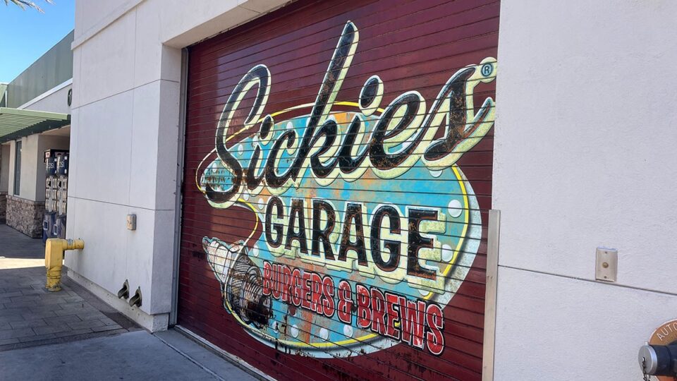 Garage-themed display featuring the Sickies Garage logo inside the restaurant
