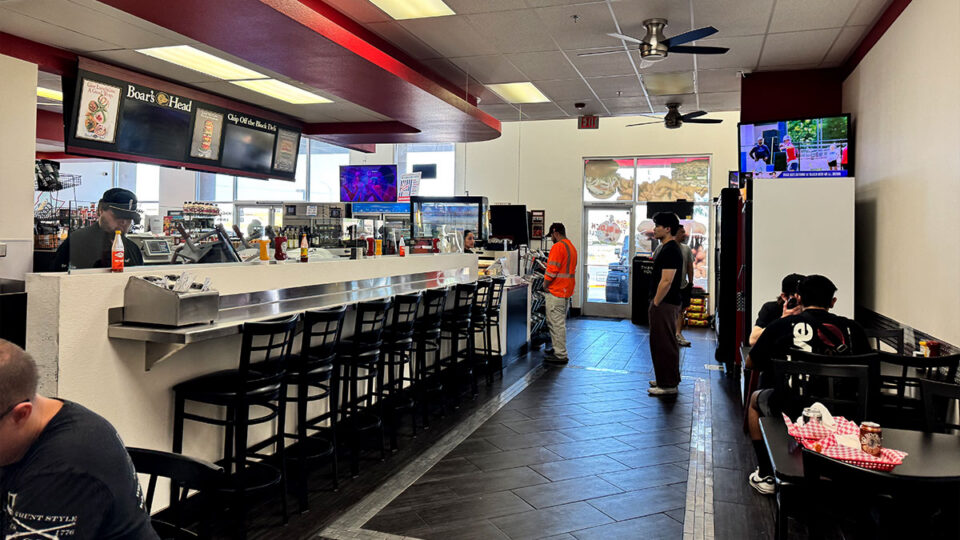 Customers waiting to order at the Chip Off the Block Deli counter.