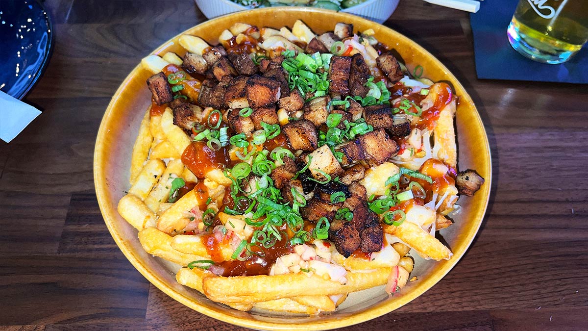 Kalua pork loaded fries with mozzarella, guava barbecue sauce, pineapple pico, and scallions.