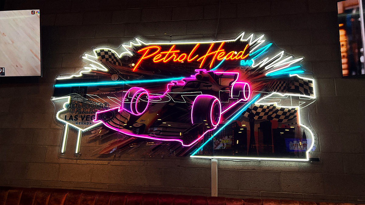 Illuminated Petrol Head neon race car sign with Las Vegas and checkered flag graphics.