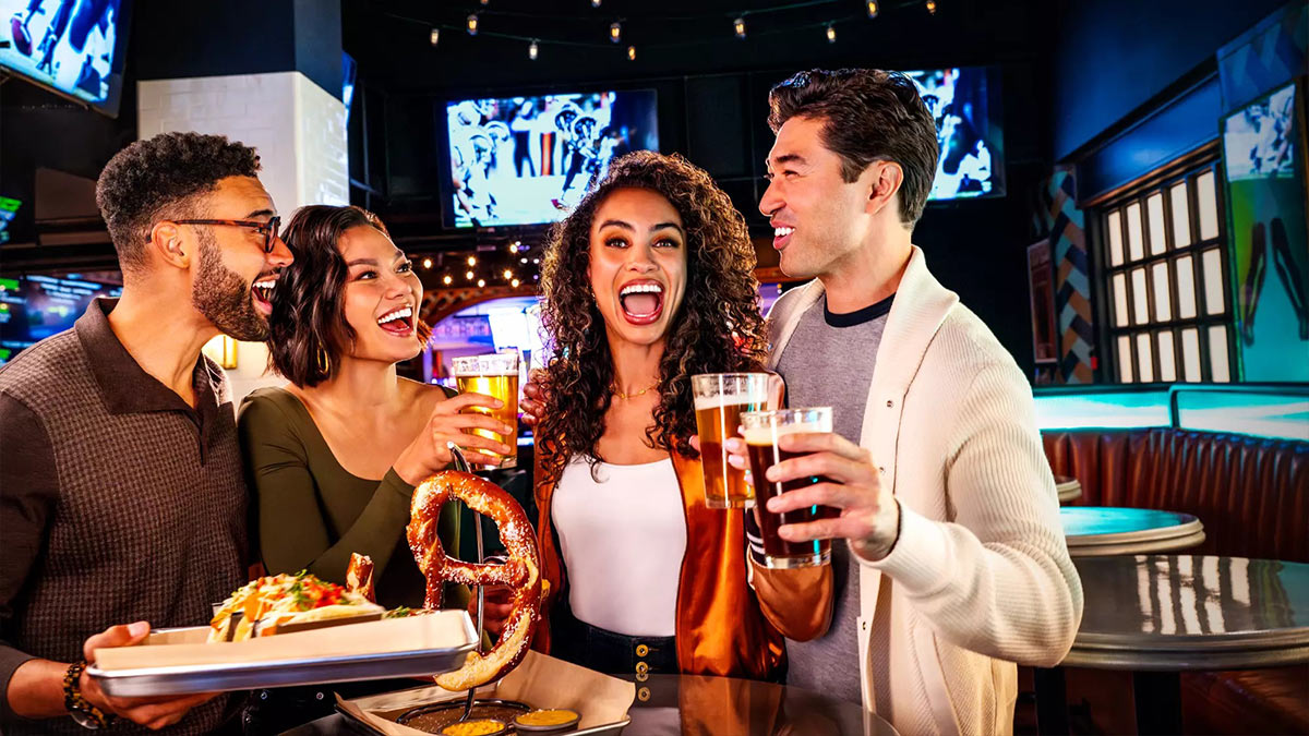 Friends enjoying drinks and food while watching sports at Park MGM in Las Vegas