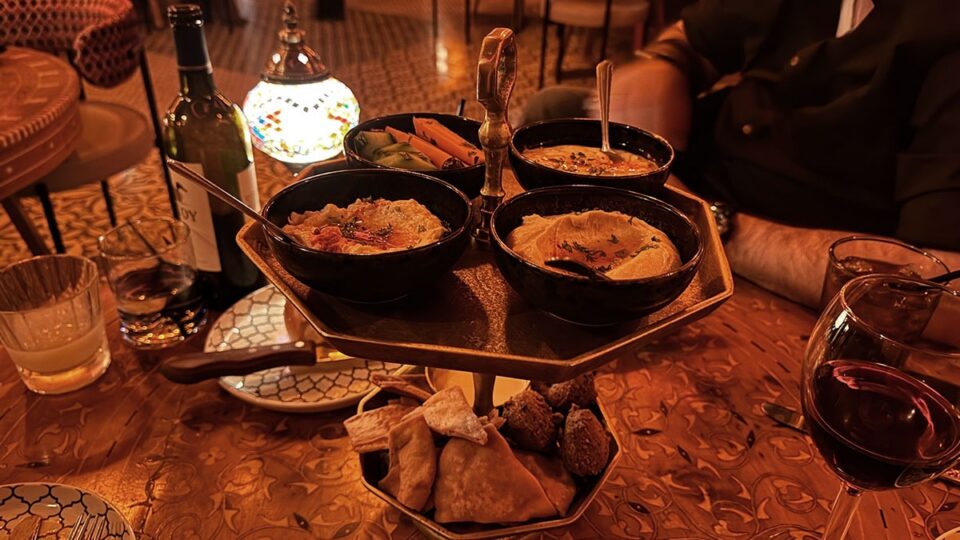 Mediterranean sampler with hummus, dips, falafel, vegetables, and pita chips at Marrakech Las Vegas.