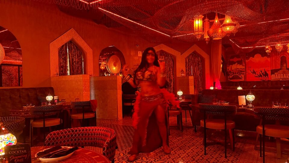 Belly dancer performing between dining tables at Marrakech Mediterranean Restaurant in Las Vegas.