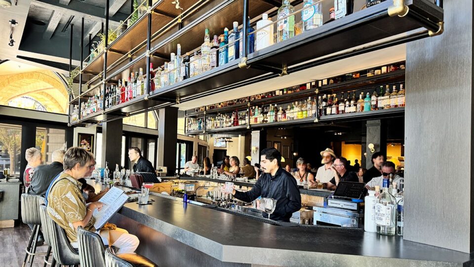 Guests dining and enjoying drinks at the bar at Al Solito Posto