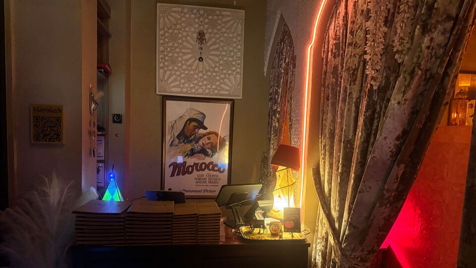 Marrakech reception area surrounded by heavy Moroccan-style curtains before entering the main dining room.