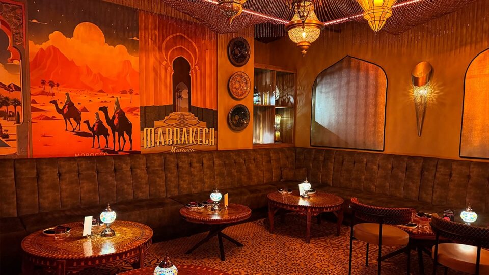 Traditional mirrors, low dining tables, ornate lanterns, and velvet sofas inside Marrakech Las Vegas.