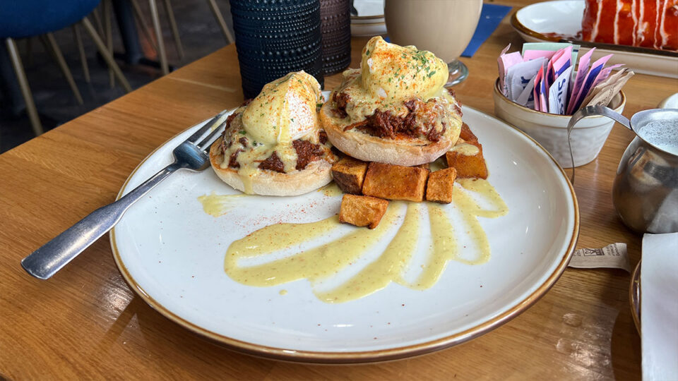 Traditional Benedict with Canadian bacon, poached egg, roasted tomato, hollandaise, and house potatoes