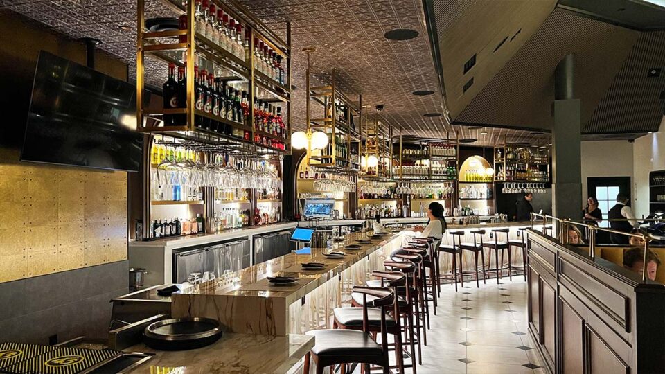 Bar inside Braseria by EDO in Las Vegas with marble counters and illuminated bottle displays