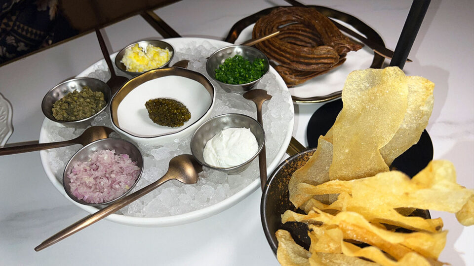 Kaluga caviar with buckwheat churros, potato chips, crème fraîche, capers and egg at Braseria by EDO
