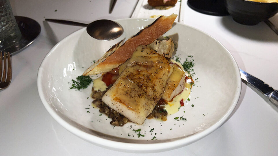 Roasted cod with green lentils, Manzanilla olive aioli and tomato-piquillo sauce at Braseria by EDO