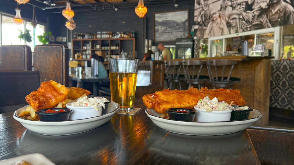 Fish and chips with coleslaw, tartar sauce and dipping sauce at Cornish Pasty Co.