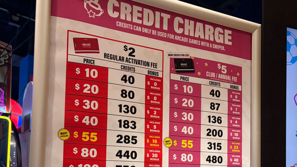 Round1 arcade credit pricing board displaying game card activation fees and credit packages for regular and club members.