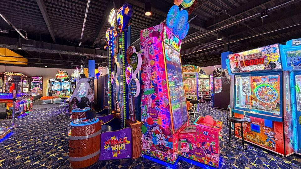 Colorful Whack N Win and Candy Crush-themed arcade machines alongside redemption games on the Round1 arcade floor.