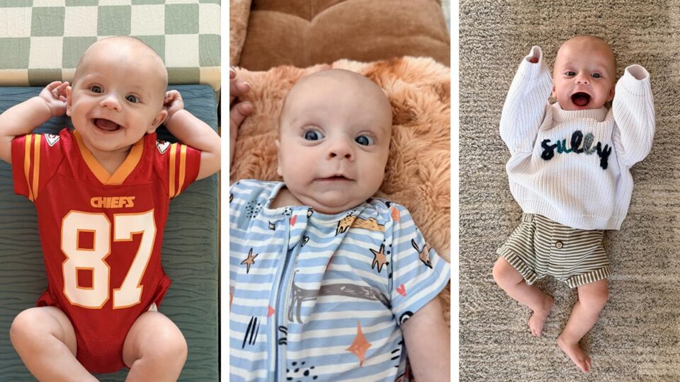 Six-month-old Sullivan smiling in a Chiefs jersey, patterned outfit, and white Sully sweater